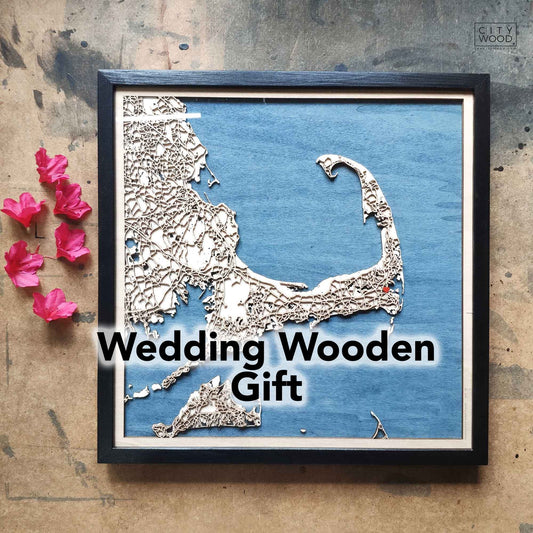 Framed wooden map of Cape Cod on blue background, pink flowers.