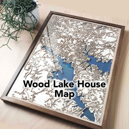 Wooden framed Wood Lake House Map, small green potted plant.